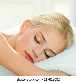 Young Beautiful Blond Woman Sleeping On Bed