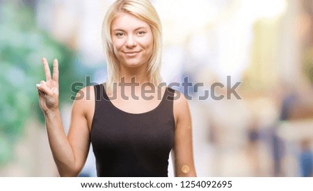 Young beautiful blonde attractive woman wearing elegant dress over isolated background showing and pointing up with fingers number two while smiling confident and happy.