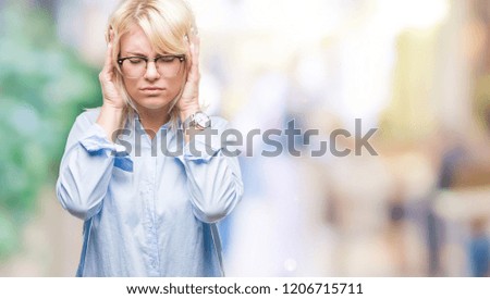 Young beautiful blonde business woman wearing glasses over isolated background with hand on head for pain in head because stress. Suffering migraine.