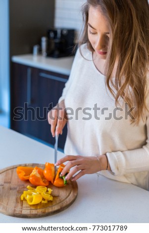 Young beautiful blonde girl in the kitchen