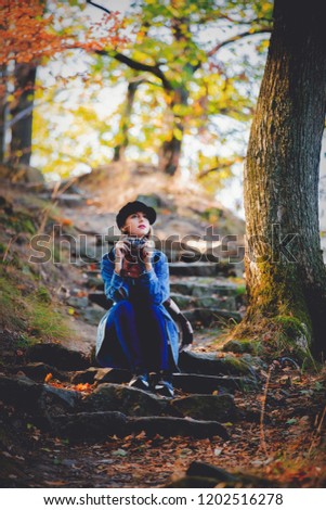 Similar – Image, Stock Photo Low angle view of blonde white girl posing in the forest with trees in the background.