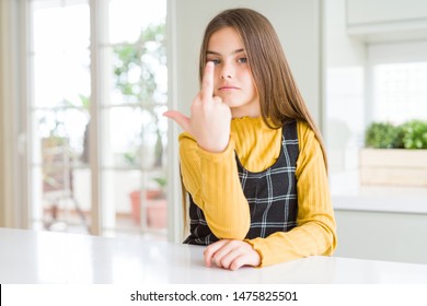 Young Beautiful Blonde Kid Girl Wearing Casual Yellow Sweater At Home Showing Middle Finger, Impolite And Rude Fuck Off Expression