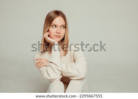 Young beautiful blonde teen girl on a light background