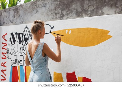 Young Beautiful Blonde Woman Painting The Wall, Street Art In Process, Street Artist - Painter