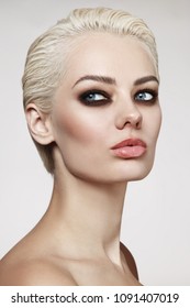 Young Beautiful Blonde Woman With Pixie Hair Cut And Smoky Eye Make-up