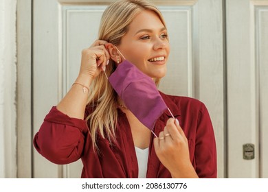 Young beautiful blonde woman puts a mask on her face - Powered by Shutterstock