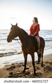 Young beautiful blonde woman ride her horse near the river