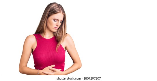 Young Beautiful Blonde Woman Wearing Elegant Summer Shirt With Hand On Stomach Because Indigestion, Painful Illness Feeling Unwell. Ache Concept. 