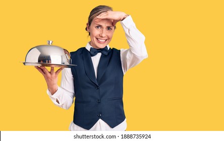 Young Beautiful Blonde Woman Wearing Waitress Uniform Holding Tray Stressed And Frustrated With Hand On Head, Surprised And Angry Face 