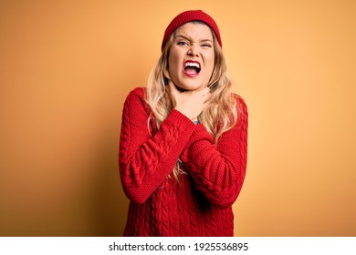 Young beautiful blonde woman wearing casual sweater and wool cap over white background shouting suffocate because painful strangle. Health problem. Asphyxiate and suicide concept.