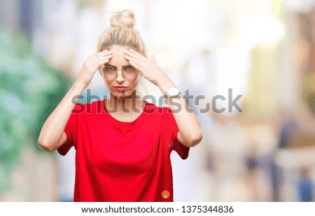 Young beautiful blonde woman wearing red t-shirt and glasses over isolated background with hand on head for pain in head because stress. Suffering migraine.