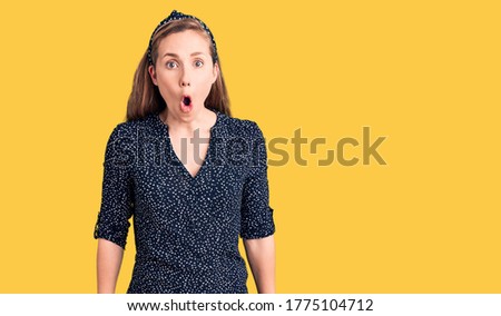 Young beautiful blonde woman wearing casual shirt scared and amazed with open mouth for surprise, disbelief face 