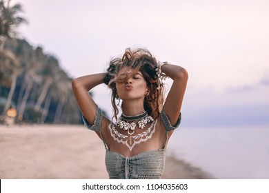 Young Beautiful Boho Woman Sending Air Kiss On The Beach At Sunset