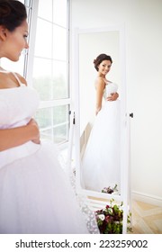 Young Beautiful Bride To Be Trying Her Dress In Shop