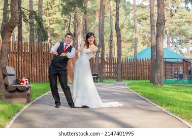 Young beautiful bride and groom dancing in the park - Shutterstock ID 2147401995