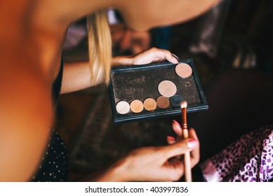 Young Beautiful Bride In A Satin Dressing Gown Doing Makeup With Burgundy Lipstick