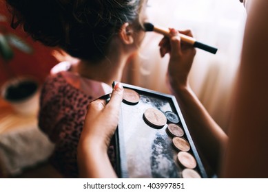 Young Beautiful Bride In A Satin Dressing Gown Doing Makeup With Burgundy Lipstick