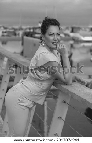 Similar – Woman at the window of a parking garage