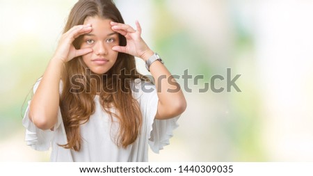 Young beautiful brunette business woman over isolated background Trying to open eyes with fingers, sleepy and tired for morning fatigue