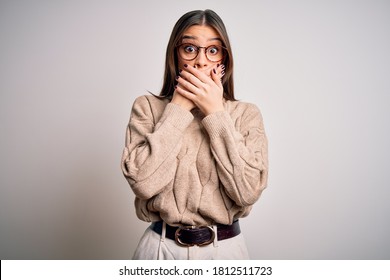Young beautiful brunette businesswoman wearing casual sweater and glasses standing shocked covering mouth with hands for mistake. Secret concept. - Shutterstock ID 1812511723