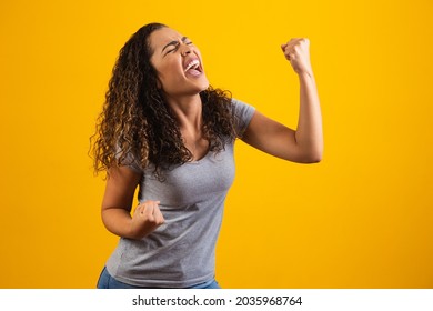 Young beautiful brunette curly hair girl happily rejoicing saying yes on yellow background. Success and achievement concept. Cheerful pretty woman on yellow background.
 - Shutterstock ID 2035968764