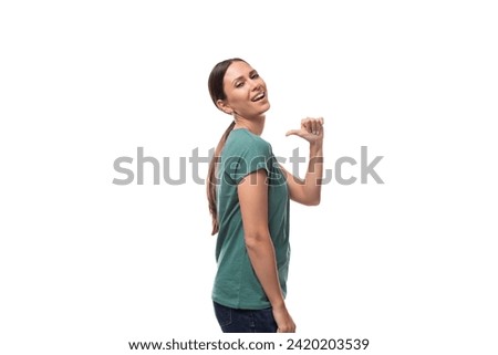 young beautiful brunette lady with a ponytail hairstyle is dressed in a green t-shirt and jeans on a white background with copy space