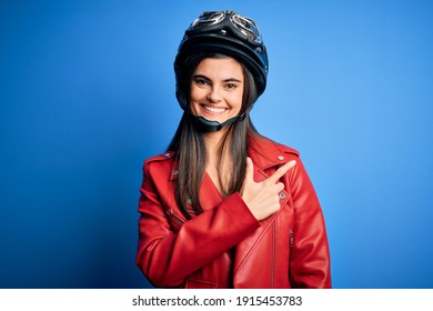 Young Beautiful Brunette Motorcycliste Woman Wearing Motorcycle Helmet And Jacket Cheerful With A Smile Of Face Pointing With Hand And Finger Up To The Side With Happy And Natural Expression On Face