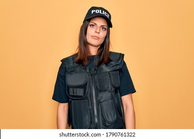 Young Beautiful Brunette Policewoman Wearing Police Uniform Bulletproof And Cap Looking Sleepy And Tired, Exhausted For Fatigue And Hangover, Lazy Eyes In The Morning.