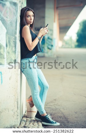 Similar – Woman with earphones listening music in smartphone