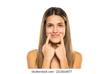 Young Beautiful Brunette Woman With Long Hair Standing Over White Background Smiling With Closed Mouth, Fingers Pointing And Forcing Cheerful Smile