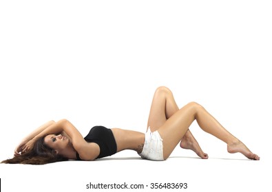 Young beautiful brunette woman with perfect body posing on white background
