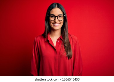 Young Beautiful Brunette Woman Wearing Casual Shirt And Glasses Over Red Background With A Happy And Cool Smile On Face. Lucky Person.