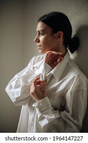Young beautiful brunette woman wearing casual shirt looking away to side. natural expression. Posing with hands