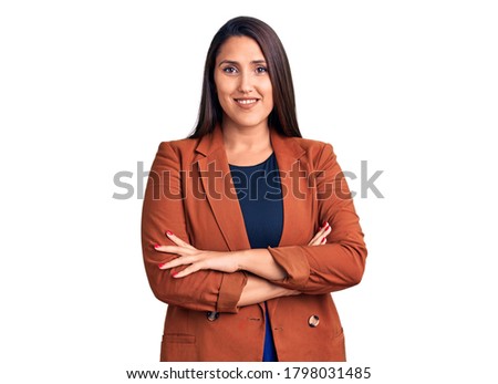Young beautiful brunette woman wearing elegant clothes happy face smiling with crossed arms looking at the camera. positive person. 