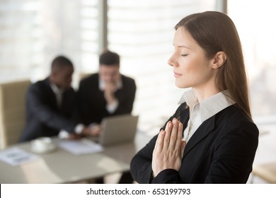 Young Beautiful Businesswoman Enjoys Meditating Standing In Office With Eyes Closed, Put Hands Together As In Prayer, Reduce Stress, Relief To Keep Calm, Positive Thinking, Appeasement, Autosuggestion