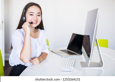 young beautiful businesswoman with headset in office