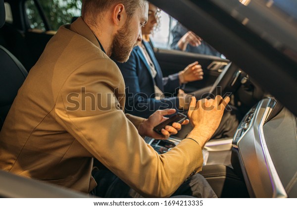 young beautiful
caucasian family came to buy new car in dealership. couple came to
see representative auto, examine all details inside and outside of
it, going to make
purchase