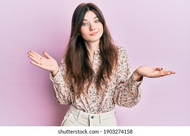 Young beautiful caucasian girl wearing elegant clothes clueless and confused expression with arms and hands raised. doubt concept. 