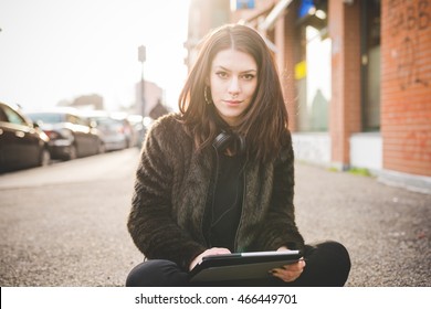 Young Beautiful Caucasian Indie Woman With Septum Piercing Using Tablet Outdoor In City Back Light, Looking At Camera Smiling - Serene, Technology, Social Network Concept