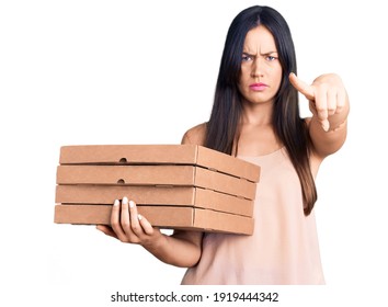 Young Beautiful Caucasian Woman Holding Delivery Pizza Box Pointing With Finger To The Camera And To You, Confident Gesture Looking Serious 