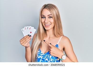 Young Beautiful Caucasian Woman Holding Poker Cards Smiling Happy Pointing With Hand And Finger 