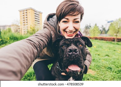 Young beautiful caucasian woman in a park outdoor taking selfie with her dog - happiness, friendship concept - Powered by Shutterstock