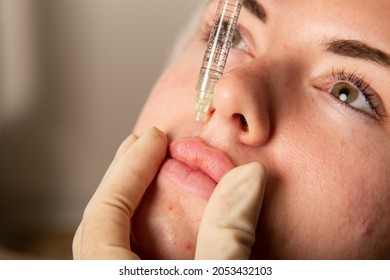 
Young beautiful caucasian woman receiving esthetic injections. Lip filler beauty procedures. Plump lips, russian lips, derma injections, full lips.  - Shutterstock ID 2053432103