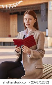 Young Beautiful Caucasian Woman In Stylish Coat Using Tablet Outdoors On Sunny Day, Reading Ebook. Attractive Female Street Portrait At Fall Or Spring. Autumn Lifestyle, Modern Wireless Technology