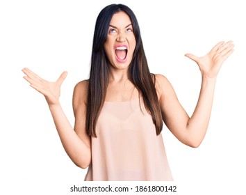 Young beautiful caucasian woman wearing casual clothes crazy and mad shouting and yelling with aggressive expression and arms raised. frustration concept. 
