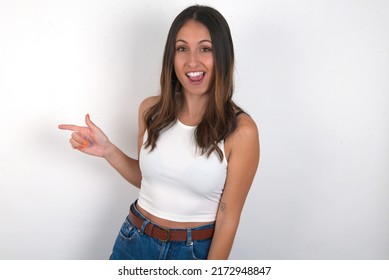 Young Beautiful Caucasian Woman Wearing White Top Over White Background Points Aside On Copy Blank Space. People Promotion And Advertising Concept