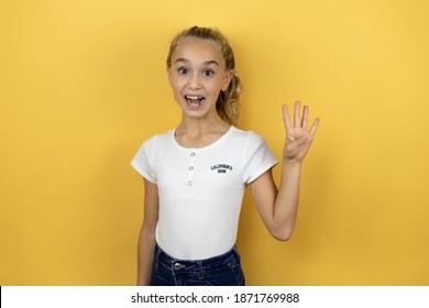 Young Beautiful Child Girl Standing Over Isolated Yellow Background Showing And Pointing Up With Fingers Number Four While Smiling Confident And Happy