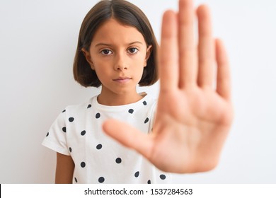 Young Beautiful Child Girl Wearing Casual T-shirt Standing Over Isolated White Background With Open Hand Doing Stop Sign With Serious And Confident Expression, Defense Gesture