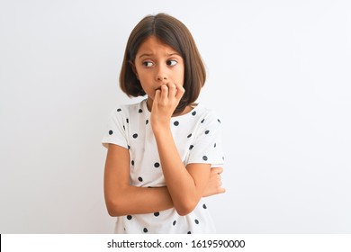 Young Beautiful Child Girl Wearing Casual T-shirt Standing Over Isolated White Background Looking Stressed And Nervous With Hands On Mouth Biting Nails. Anxiety Problem.