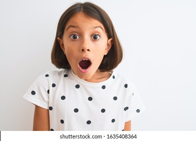 Young Beautiful Child Girl Wearing Casual T-shirt Standing Over Isolated White Background Scared In Shock With A Surprise Face, Afraid And Excited With Fear Expression